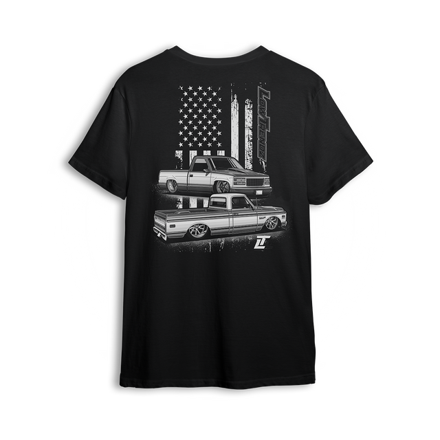 T-shirt featuring a slammed C10 and OBS combo with a gritty American flag backdrop and bold Low Trendz branding. Blending old-school style with street flex, this t-shirt is built for true truck fans and show season vibes.