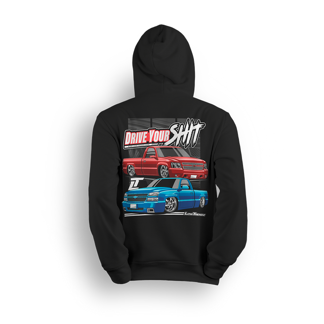 Hoodie featuring two slammed Silverados rolling on a checkered track floor with bold red-and-black styling. The “Just Drive Your Shit” hoodie is a callout to real show truck owners who drive their builds—no trailers, no excuses.