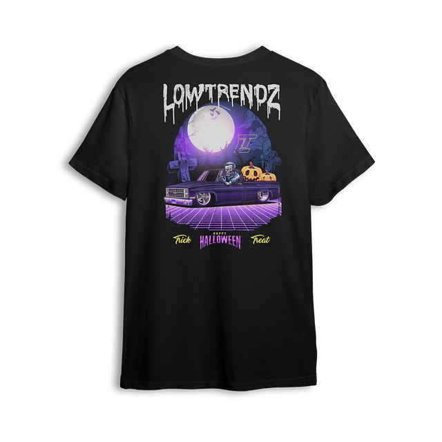 Halloween t-shirt featuring a slammed Squarebody in a graveyard at night with a full moon and skeleton behind the wheel