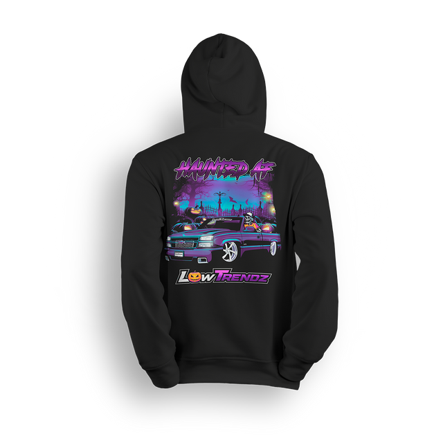 Black hoodie with spooky Halloween design featuring slammed Chevy Silverado in graveyard with jack-o-lanterns and skeleton reaper