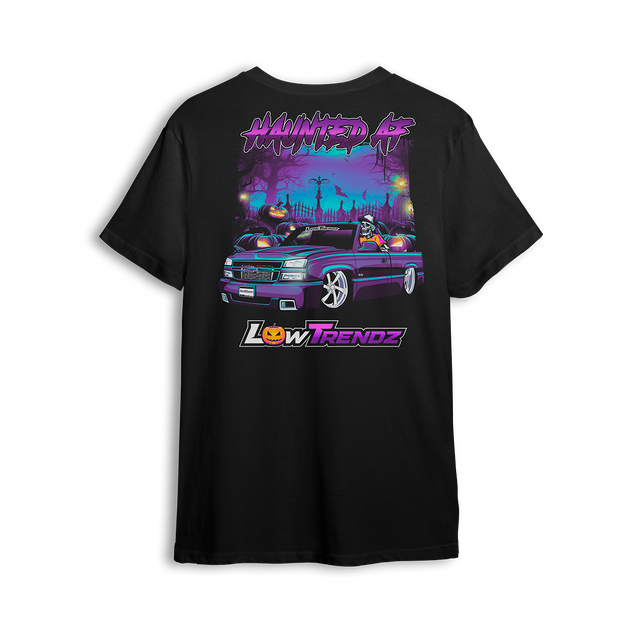 Black t-shirt with spooky Halloween artwork of a slammed Chevy Silverado in graveyard scene with skeleton driver and jack-o-lanterns