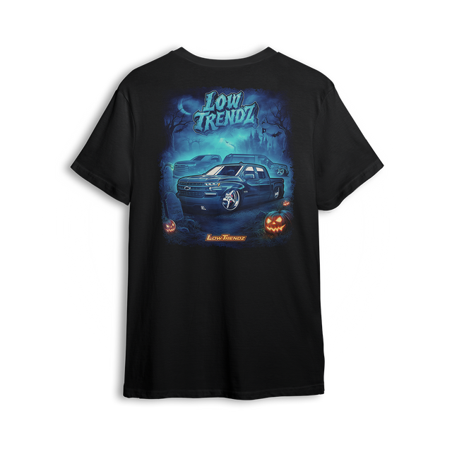Halloween 2025 t-shirt featuring a slammed Chevy truck, glowing jack-o’-lanterns, and foggy haunted artwork by Low Trendz