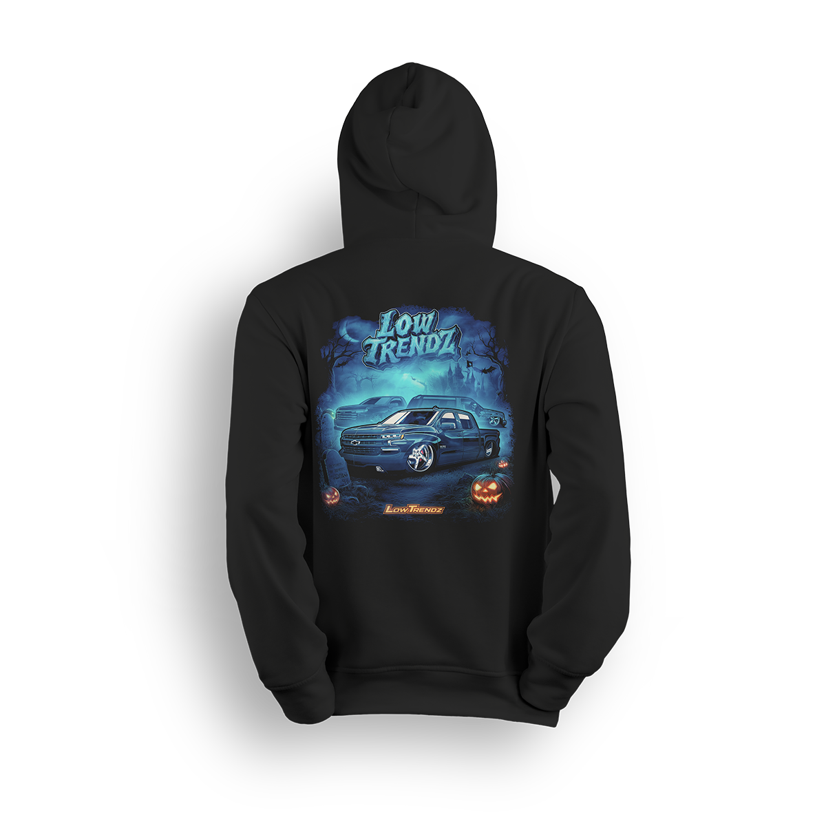 Halloween 2025 hoodie featuring a slammed Chevy truck, glowing jack-o’-lanterns, and foggy haunted artwork by Low Trendz
