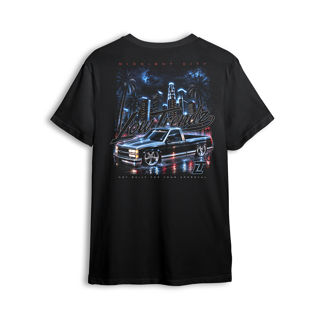 Midnight City Tee back print - black lowered OBS under a neon city skyline