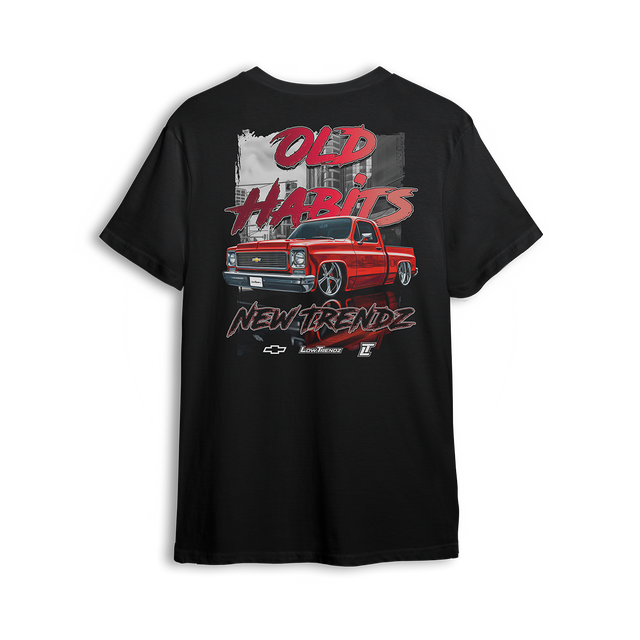 T-shirt featuring a fire red slammed Chevy Squarebody set against a gritty city backdrop with bold “Old Habits, New Trendz” lettering. This t-shirt blends classic attitude with modern style, made for builders who respect the roots and push the scene forward.