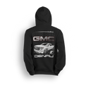 Hoodie featuring a slammed GMC Denali with bold grille and clean stance, illustrated over a sleek grid backdrop. The Arctic Denali hoodie blends full-size luxury with street style for a standout look in the custom truck scene.