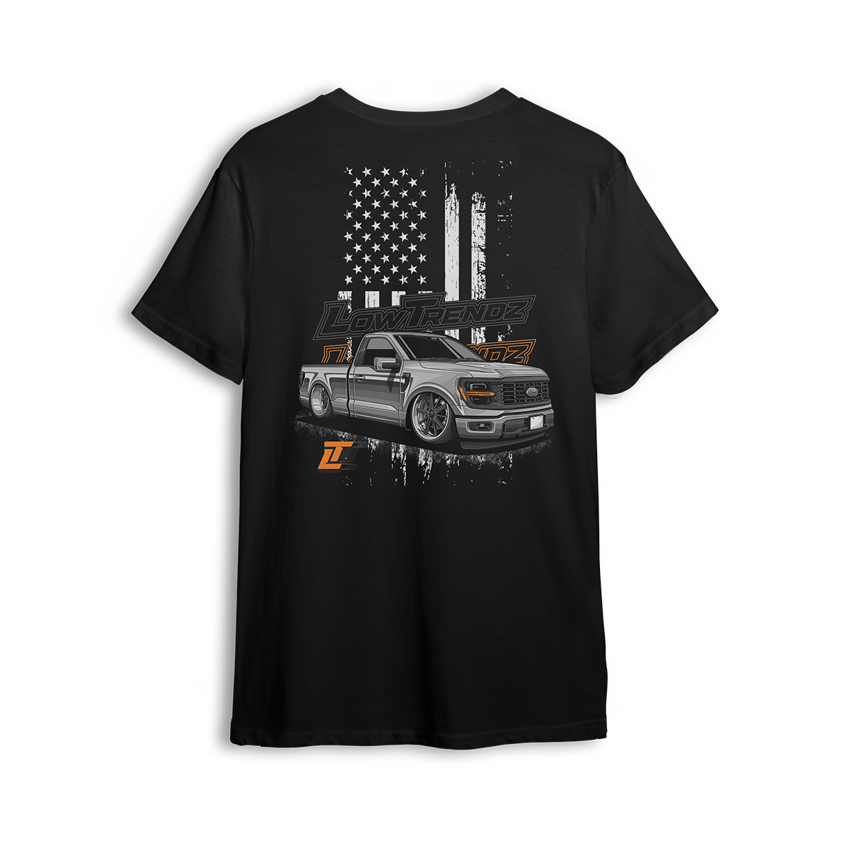 T-shirt featuring a slammed, murdered-out single cab Ford F-150 in front of a distressed American flag with burnt orange Low Trendz branding. The Stars, Stripes & Stance t-shirt delivers bold Ford energy and custom street presence for true lifestyle reps.