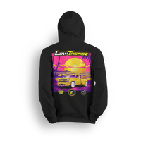 Hoodie featuring a slammed yellow Silverado baby dually set in a neon sunset with palm trees, purple tones, and golden glow. The Lemon Drop hoodie, a Da Shop x Low Trendz collab, brings tropical vibes and summer-style flex to the custom truck scene.