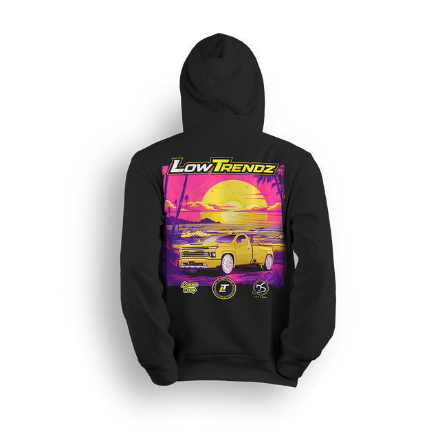Hoodie featuring a slammed yellow Silverado baby dually set in a neon sunset with palm trees, purple tones, and golden glow. The Lemon Drop hoodie, a Da Shop x Low Trendz collab, brings tropical vibes and summer-style flex to the custom truck scene.