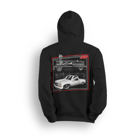 Hoodie featuring two slammed OBS Chevy trucks side by side one black at the pump and one white ready to roll. Framed in red and full of street style, the Double Trouble hoodie brings bold energy for true custom truck fans.