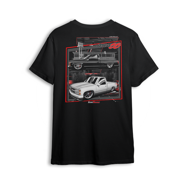 T-shirt featuring two slammed OBS Chevy trucks side by side one black at the pump and one white ready to roll. Framed in red and full of street style, the Double Trouble t-shirt brings bold energy for true custom truck fans.