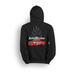 Hoodie featuring a slammed red Chevy truck with silver hot-rod flames down the sides and chrome flames bursting behind an oversized Low Trendz logo. The Flame Drop hoodie brings high-octane energy and bold street presence.