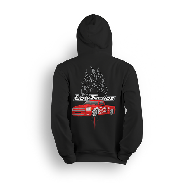 Hoodie featuring a slammed red Chevy truck with silver hot-rod flames down the sides and chrome flames bursting behind an oversized Low Trendz logo. The Flame Drop hoodie brings high-octane energy and bold street presence.