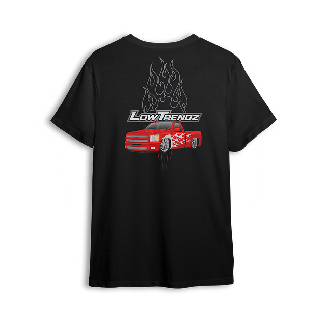 T-shirt featuring a slammed red Chevy truck with silver hot-rod flames down the sides and chrome flames bursting behind an oversized Low Trendz logo. The Flame Drop t-shirt brings high-octane energy and bold street presence.