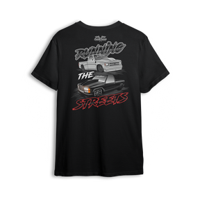 T-shirt featuring a slammed silver C10 and murdered-out OBS truck in a bold drag-ready layout with burnout marks and street-style font. The Running the Streets t-shirt captures boosted attitude, full-send energy, and late-night racing vibes.