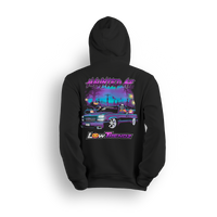Black hoodie with spooky Halloween design featuring slammed Chevy Silverado in graveyard with jack-o-lanterns and skeleton reaper