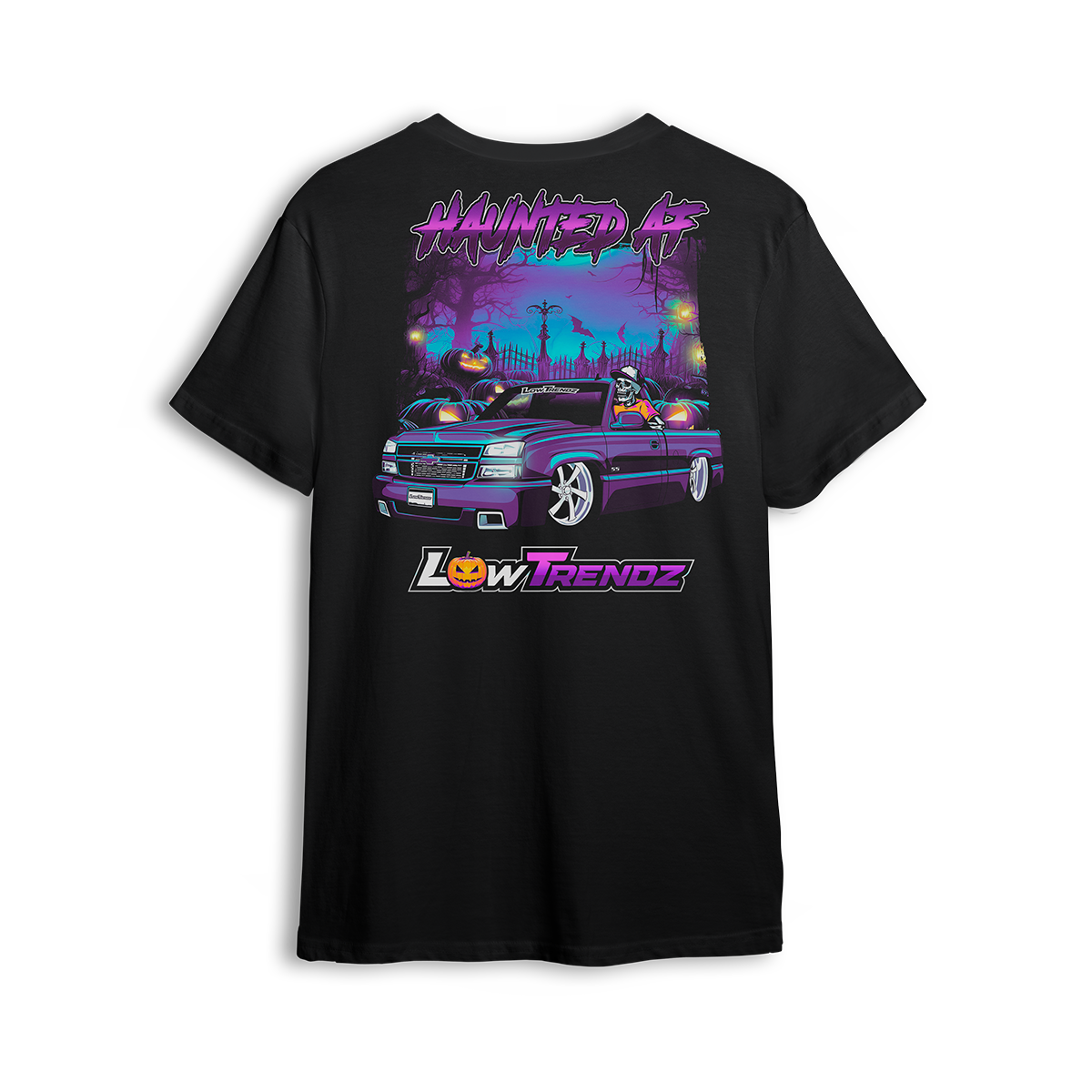 Black t-shirt with spooky Halloween artwork of a slammed Chevy Silverado in graveyard scene with skeleton driver and jack-o-lanterns